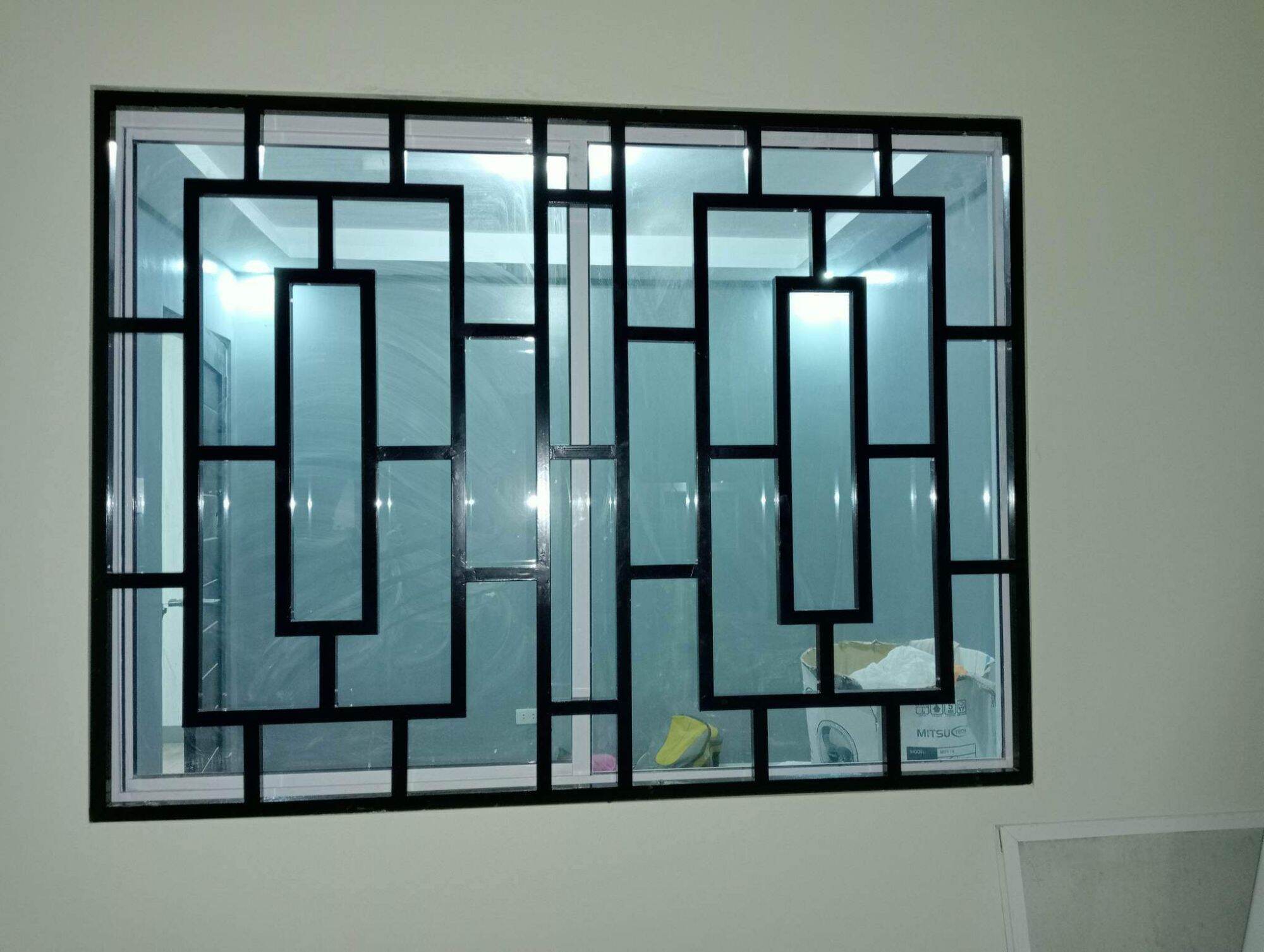 Modern stainless steel window grill in Hyderabad home